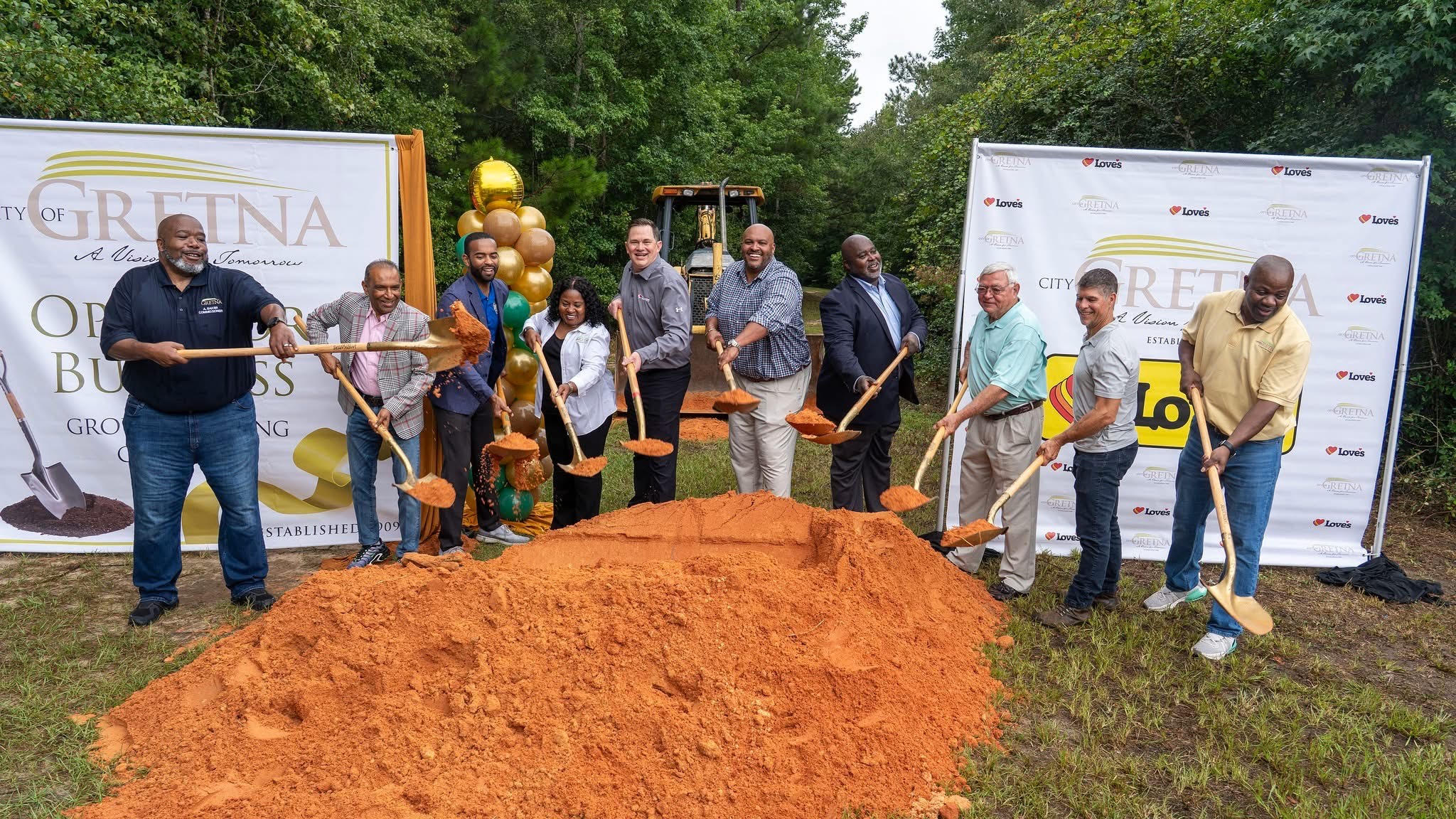 Stakeholders ceremoniously break ground at the site of the Love’s Travel Center that is set to open in Gretna