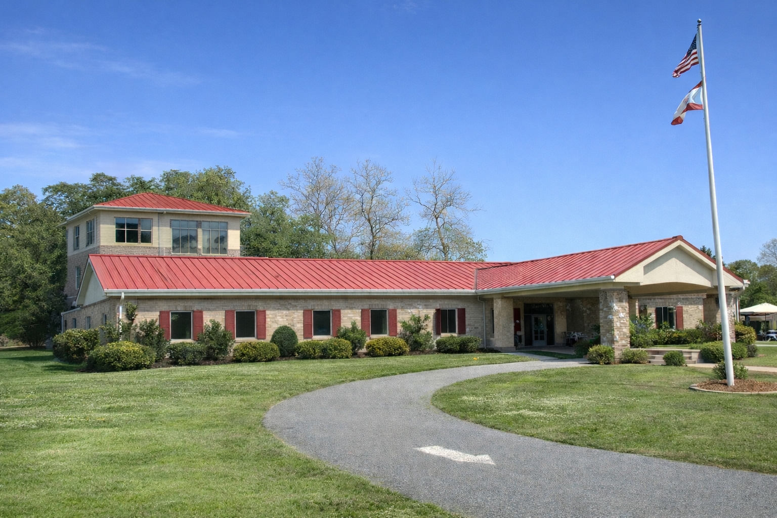 Havana Library MPCF exterior building with red metal roof, landscaped entrance, American and Florida state flags, community library facility.