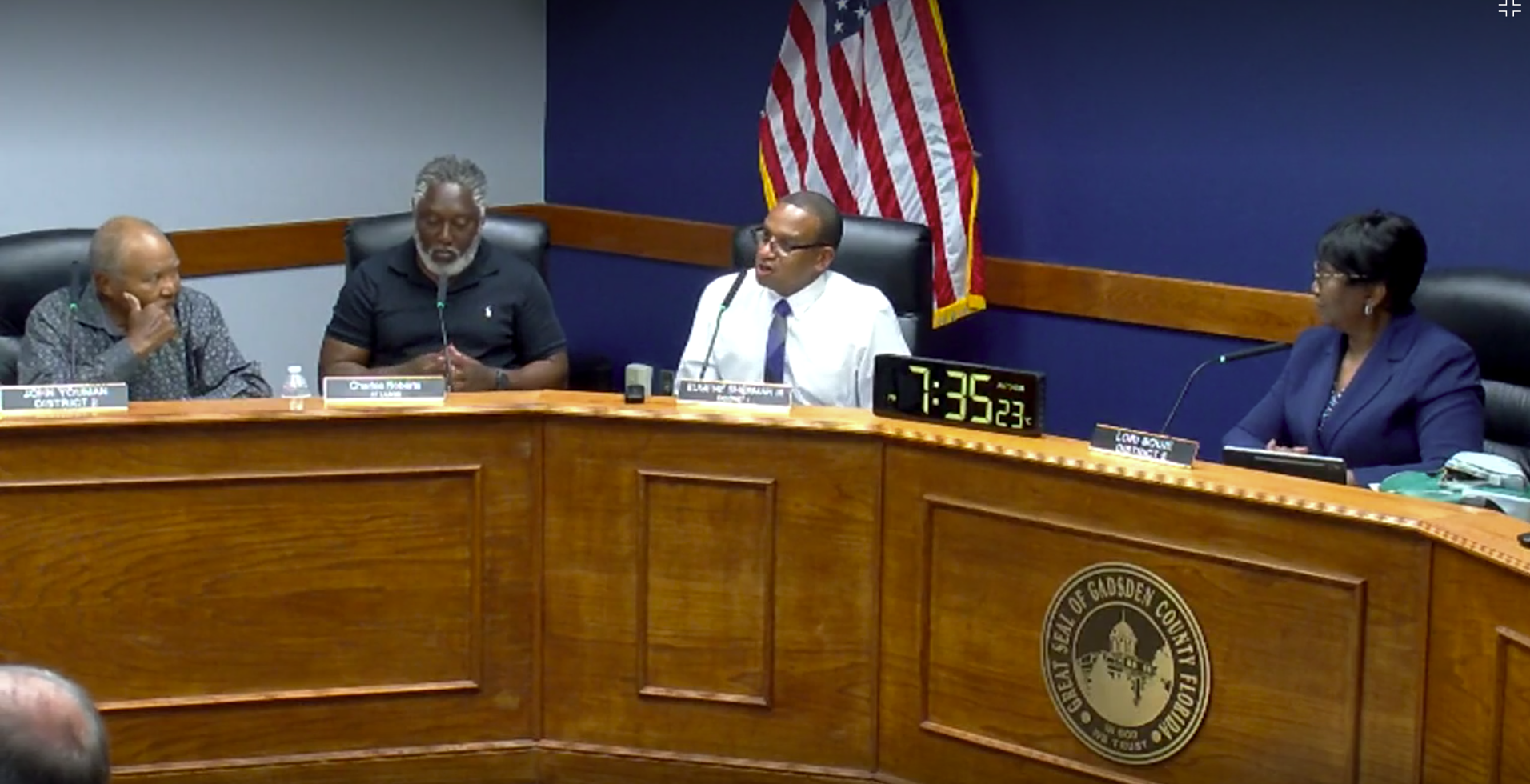 Gadsden County Board of County Commissioners meeting in session, with officials seated at the dais discussing agenda items in a formal chamber setting.